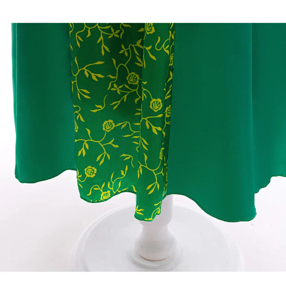close-up of emerald green princess dress hemline with gold trim